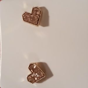 Pink hearts in gold tone stud earrings.
